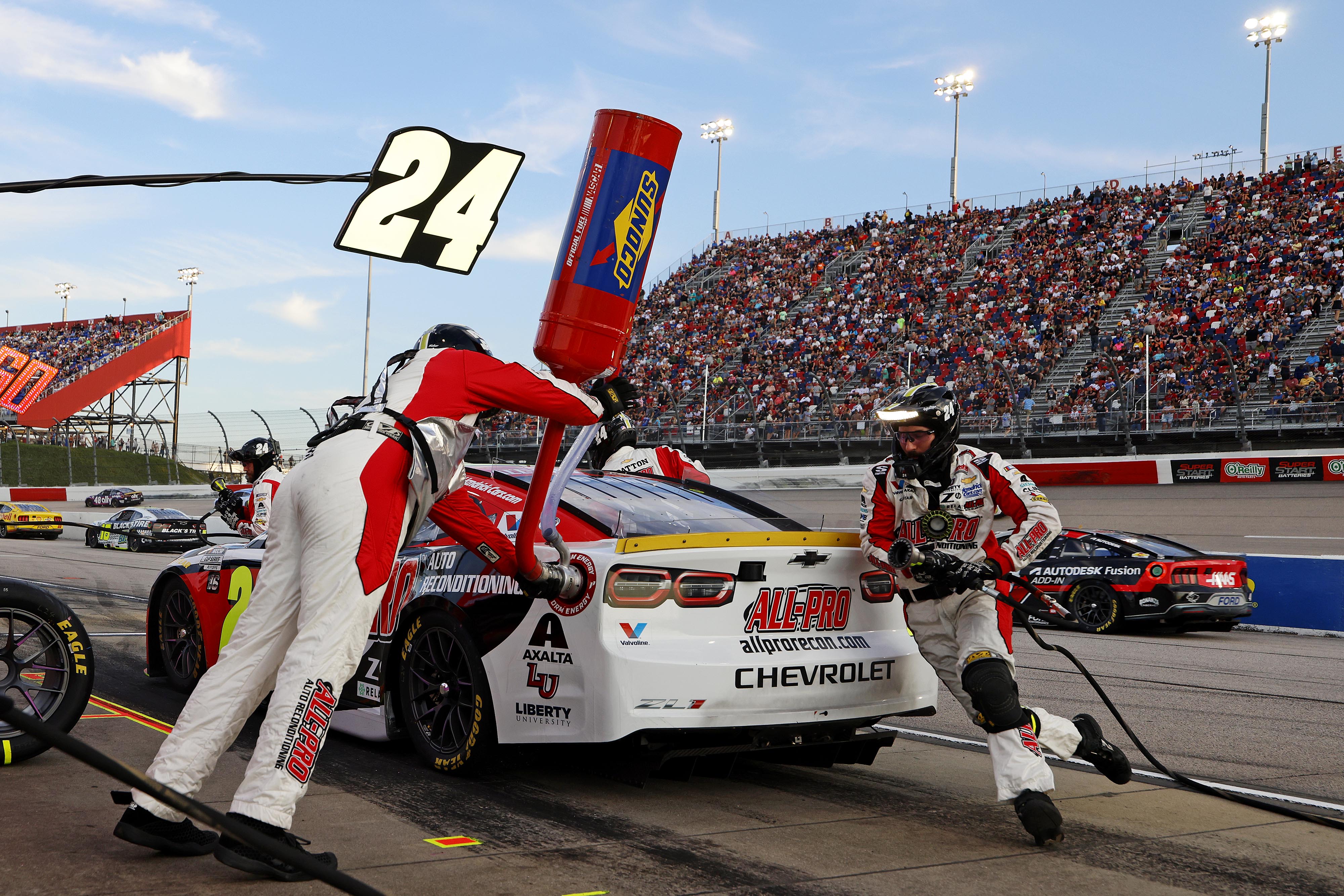 No. 24 pit crew executing a pit stop at full speed